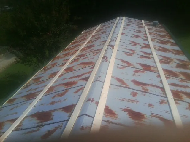 Rusted metal roof panels with new wood purlins before replacement — Storm Damage Roof Repair in Gaffney by Roofing Brothers